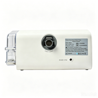 Rear view of home ventilator showing gas outlet, power connection and humidifier